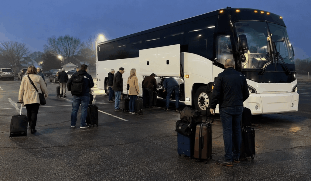 charter bus loading passengers and luggage before an early morning airport transfer from akron to cleveland hopkins airport