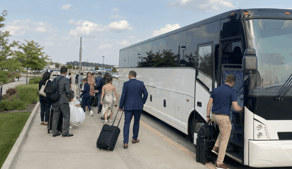 group travelers unloading luggage from a charter bus at cleveland hopkins airport departures area