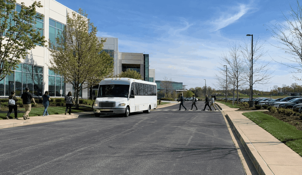 employee shuttle bus operating between office buildings and parking areas at a corporate campus in akron