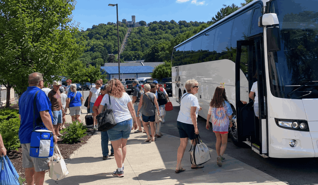 charter bus with group travelers preparing for a day trip near akron, ohio with regional attractions in the background