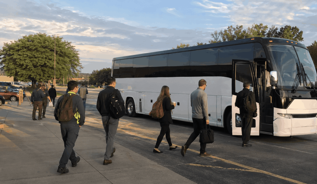 charter bus transporting employees from a remote parking lot to a workplace in akron