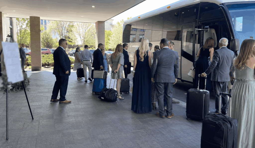 Wedding guests boarding a shuttle bus from a hotel before traveling to an Akron wedding venue