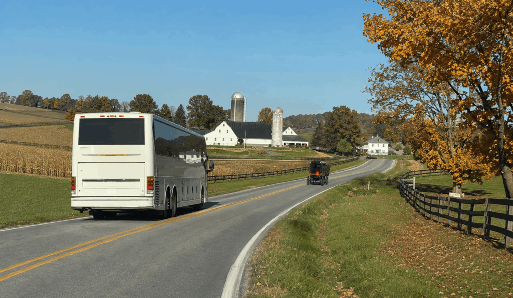 group enjoying a family-style amish meal after arriving by charter bus in holmes county ohio