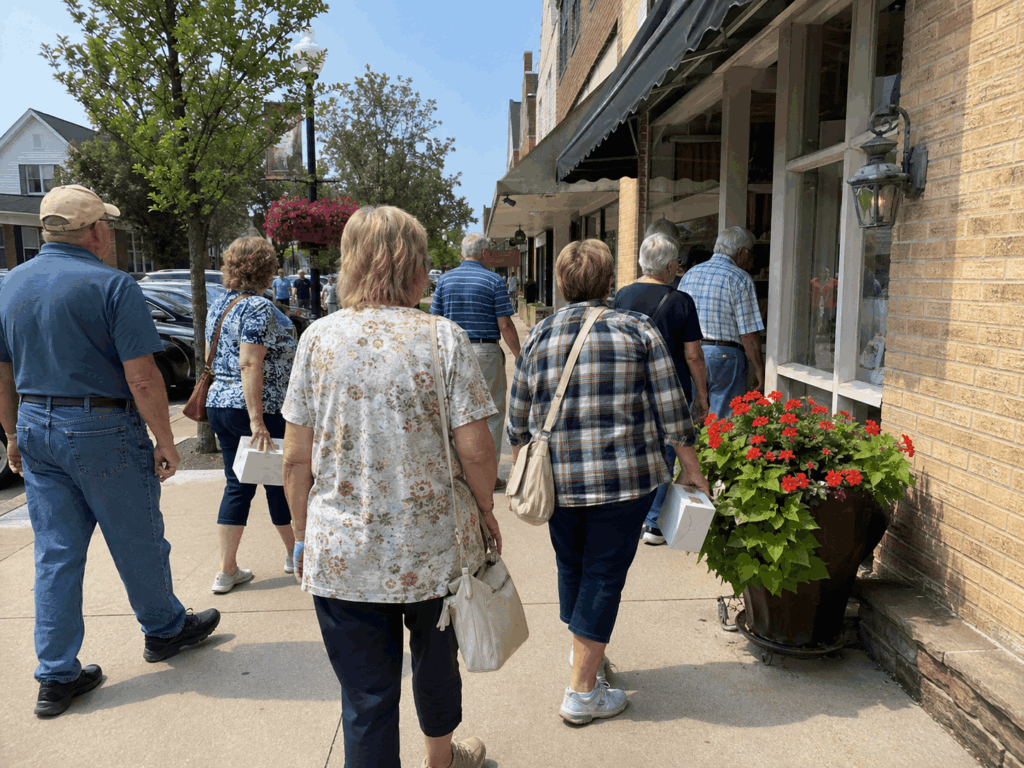 group travelers exploring bakery and specialty shops in berlin ohio during an amish country day trip