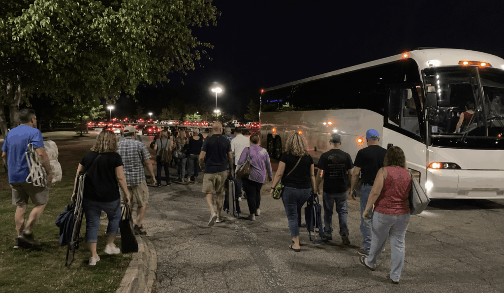 concert attendees boarding a charter bus after a show at blossom music center