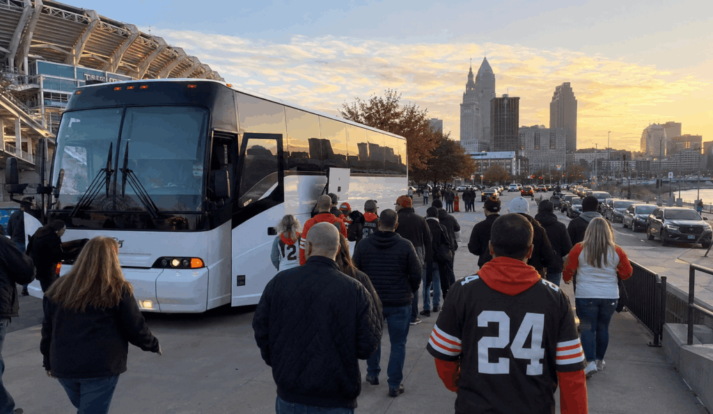 browns fans tailgating beside a charter bus near huntington bank field before kickoff