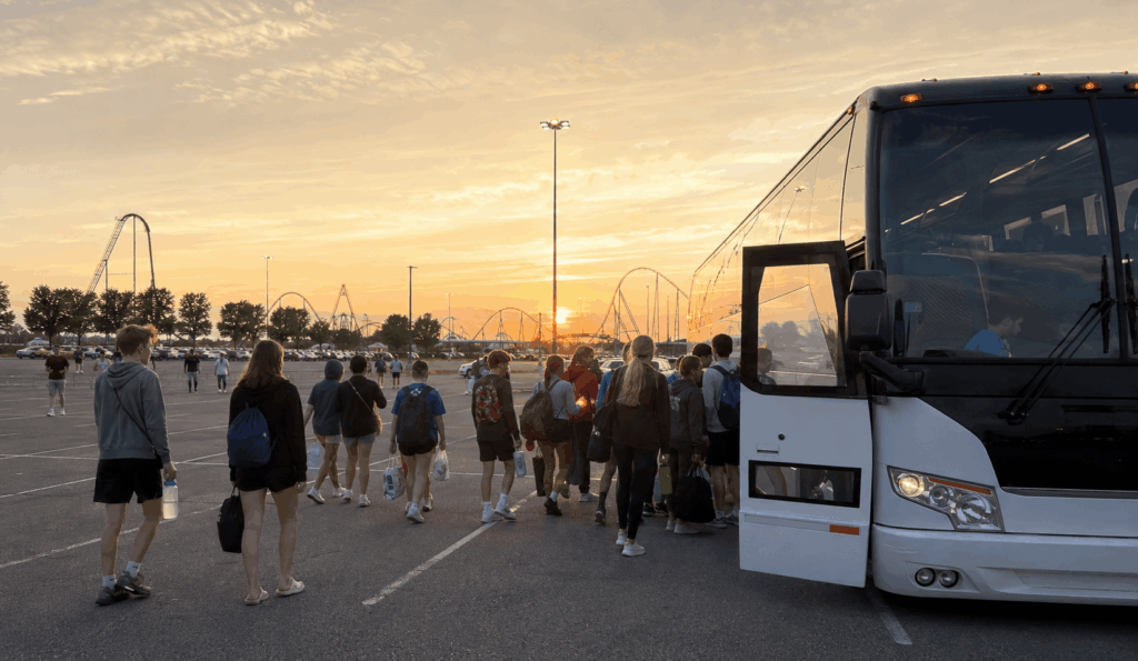 youth group gathering outside cedar point after arriving together on a charter bus