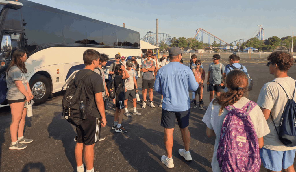 group reboarding a charter bus outside cedar point after a full day at the amusement park