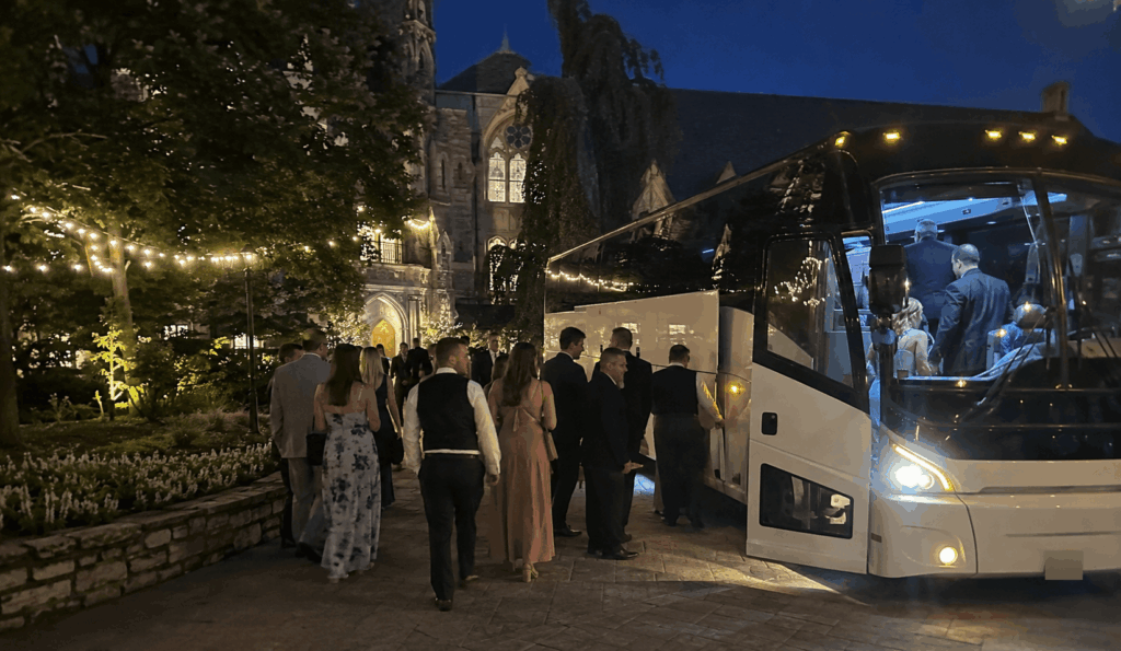 wedding guests boarding a charter bus for transportation back to their hotel after an akron wedding reception