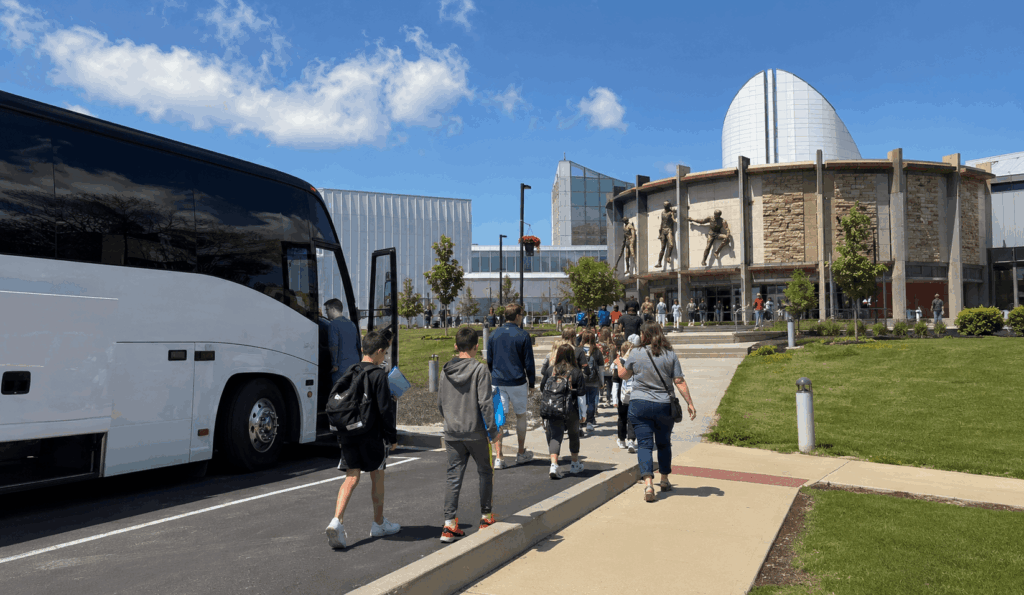 school group arriving by charter bus near the pro football hall of fame in canton, ohio