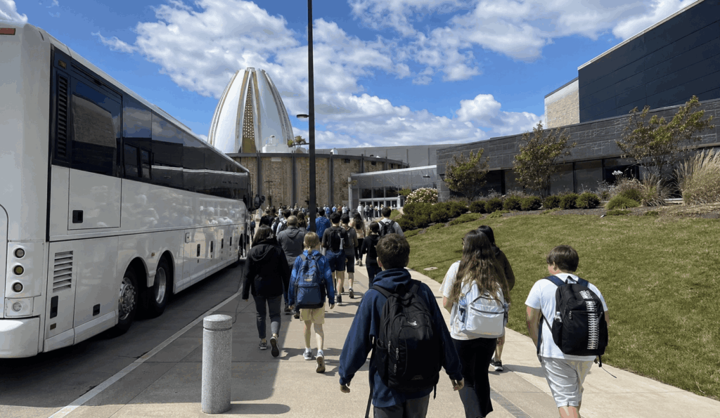 charter bus arriving near tom benson hall of fame stadium during a football event in canton