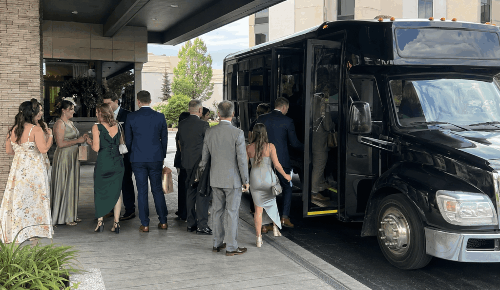wedding guests boarding a shuttle from an akron hotel before traveling to a wedding venue